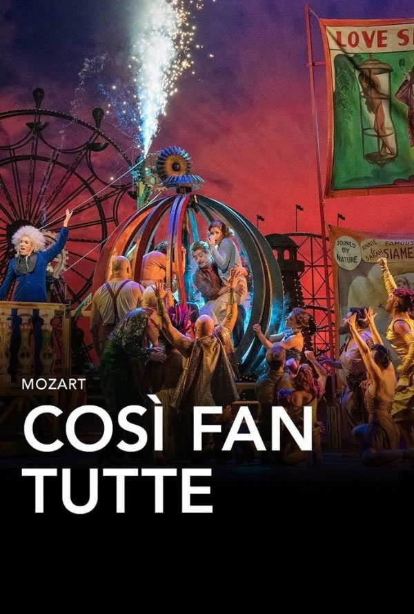 Stage performance of Mozart's Così fan tutte: performers surround a glowing spherical set under a colorful sky. Fireworks and banners frame the scene.